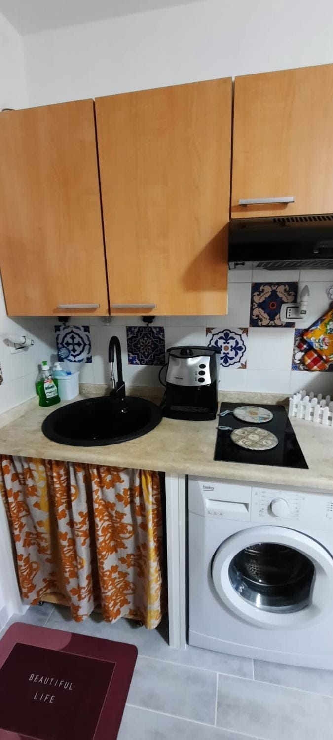 Kitchen or kitchenette, stove, washing machine