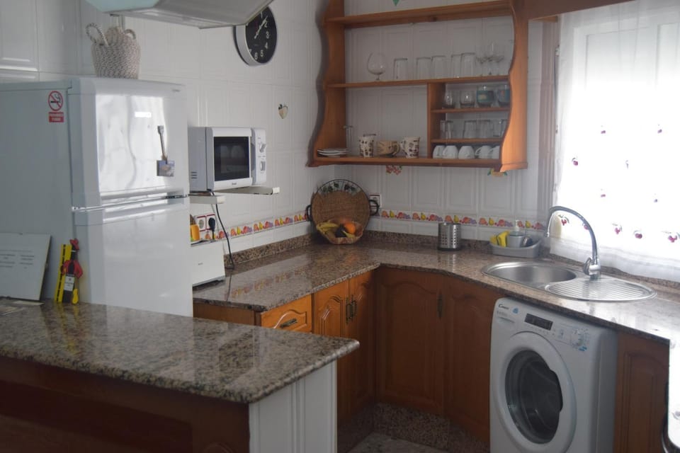 Kitchen or kitchenette, oven, stove, washing machine