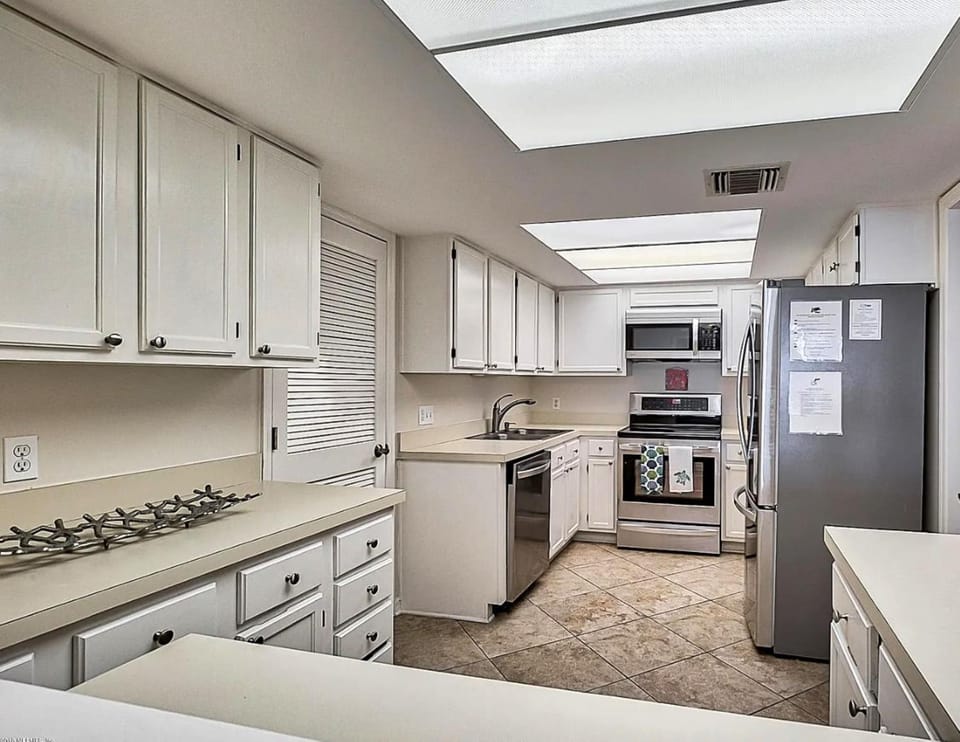 Kitchen or kitchenette, dishwasher, microwave, oven, stove
