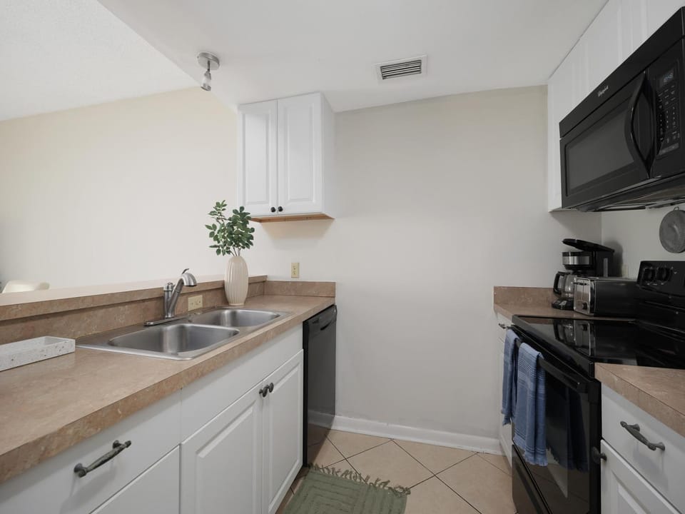 Kitchen or kitchenette, dishwasher, microwave, oven, stove, air conditioner