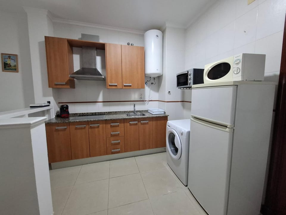 Kitchen or kitchenette, oven, stove, toaster, washing machine