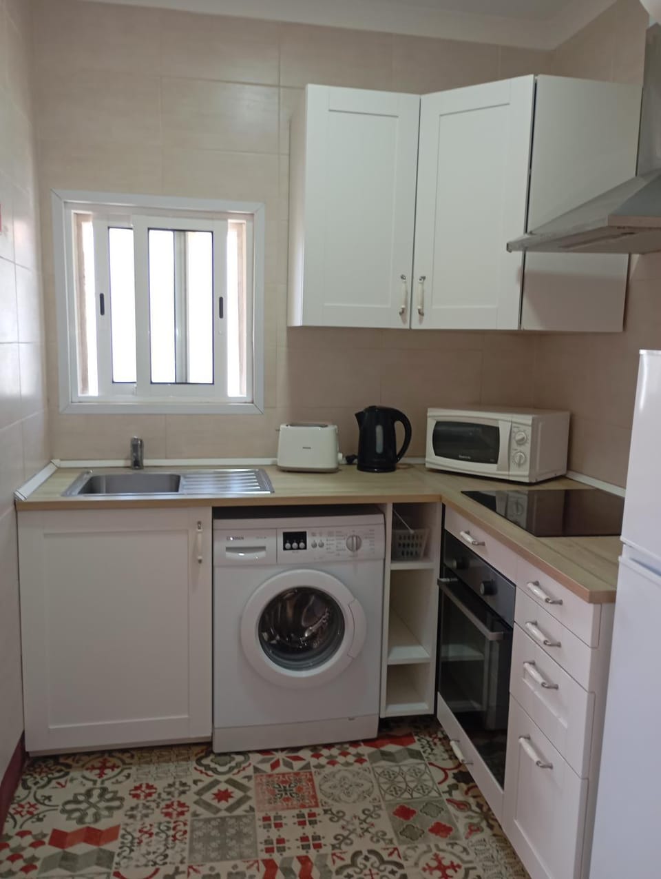 Kitchen or kitchenette, dishwasher, oven, stove, toaster, washing machine