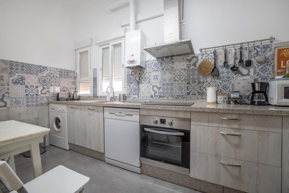 Kitchen or kitchenette, dishwasher, microwave, oven, stove, toaster, washing machine