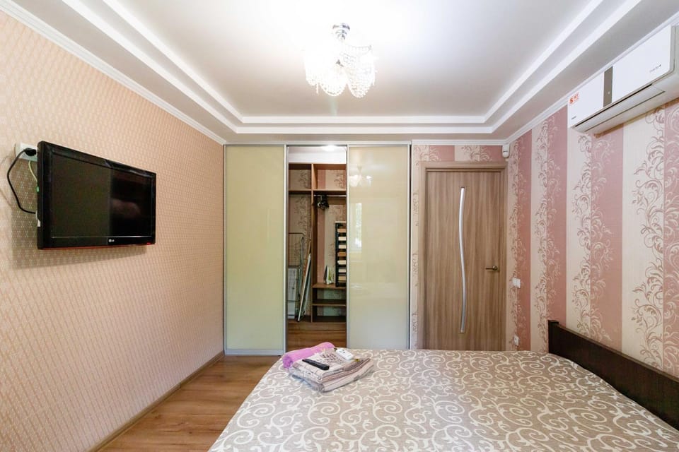 Bed, TV and multimedia, Seating area, Bedroom, furniture, furniture, towels, wardrobe, air conditioner