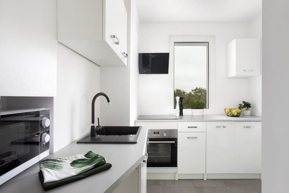 Kitchen or kitchenette, microwave, oven, stove, washing machine