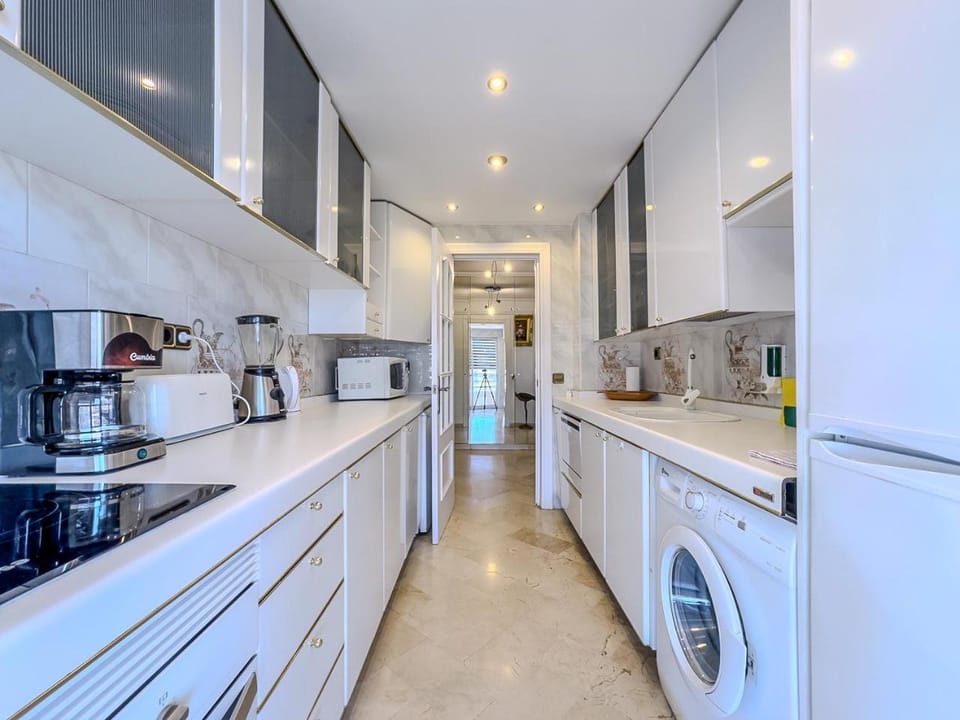 Kitchen or kitchenette, stove, toaster, washing machine