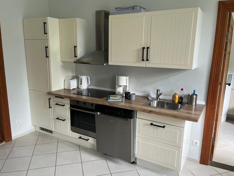 Kitchen or kitchenette, dishwasher, oven, stove