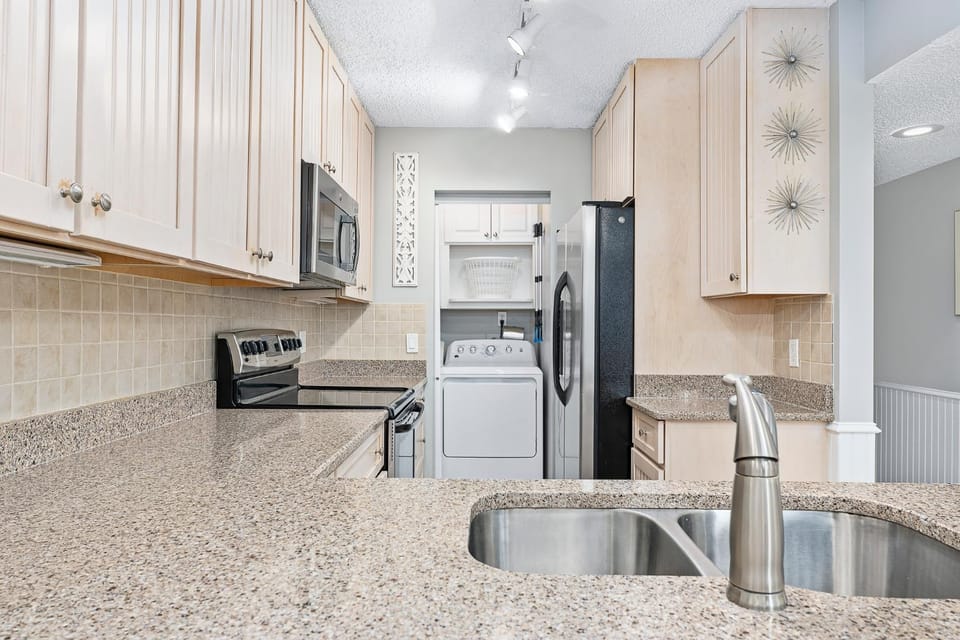 Kitchen or kitchenette, microwave, stove, washing machine, dryer