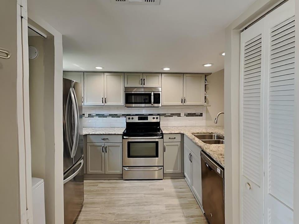 Kitchen or kitchenette, dishwasher, microwave, oven, stove