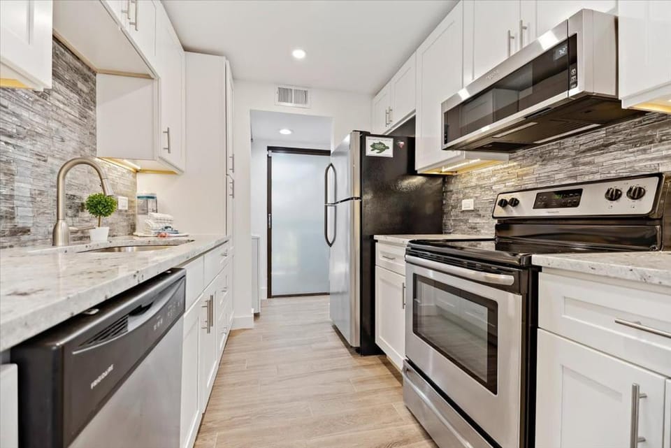 Kitchen or kitchenette, dishwasher, microwave, oven, stove