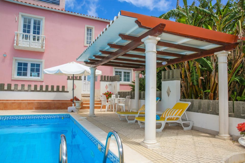 Property building, Patio, Pool view, Swimming pool, sunbed