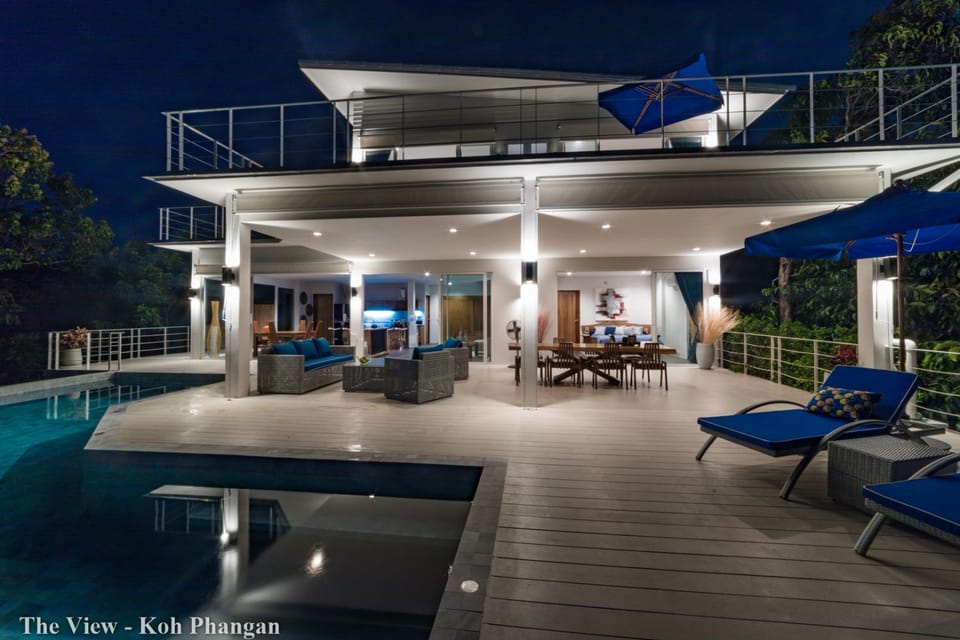 Property building, Patio, Night, View (from property/room), Balcony/Terrace, Living room, Seating area, Pool view, Swimming pool, sunbed