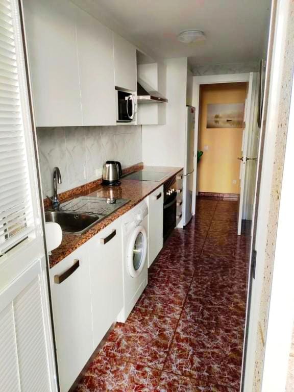Kitchen or kitchenette, microwave, oven, stove, washing machine