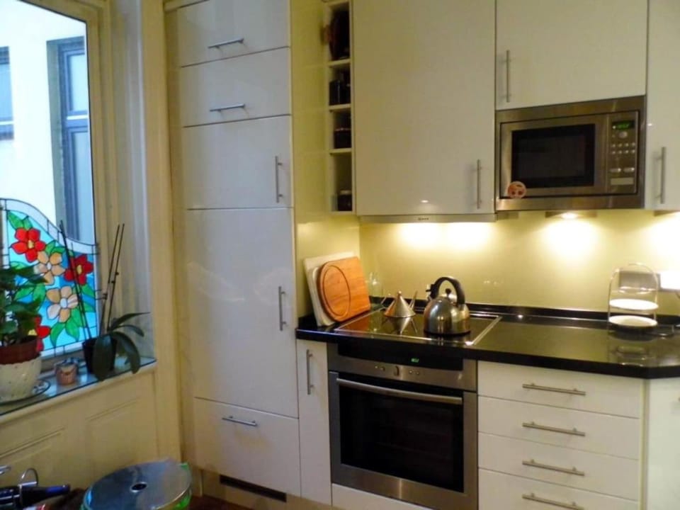 Kitchen or kitchenette, dishwasher, microwave, oven, stove