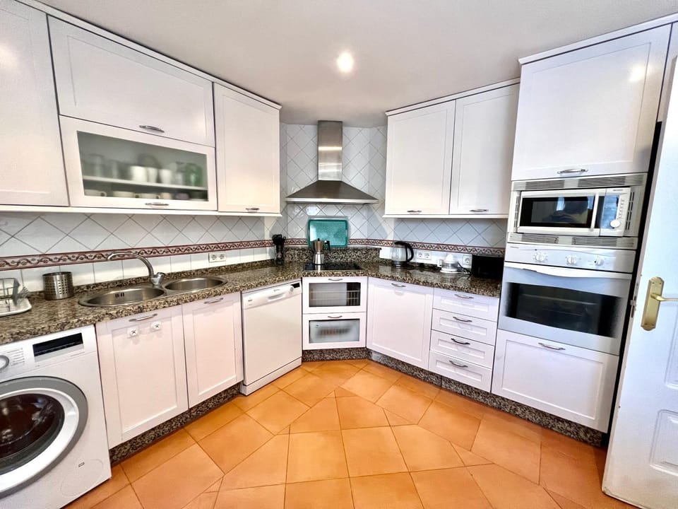 Kitchen or kitchenette, dishwasher, oven, stove, washing machine
