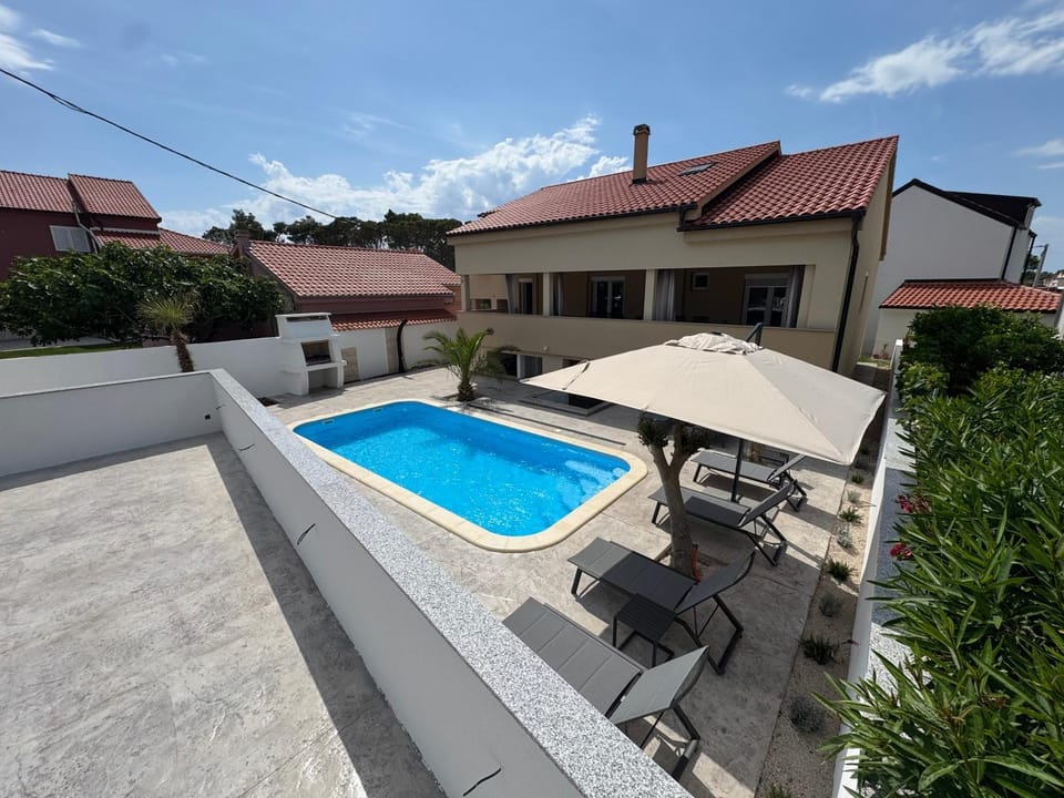 Property building, Pool view, Swimming pool, sunbed