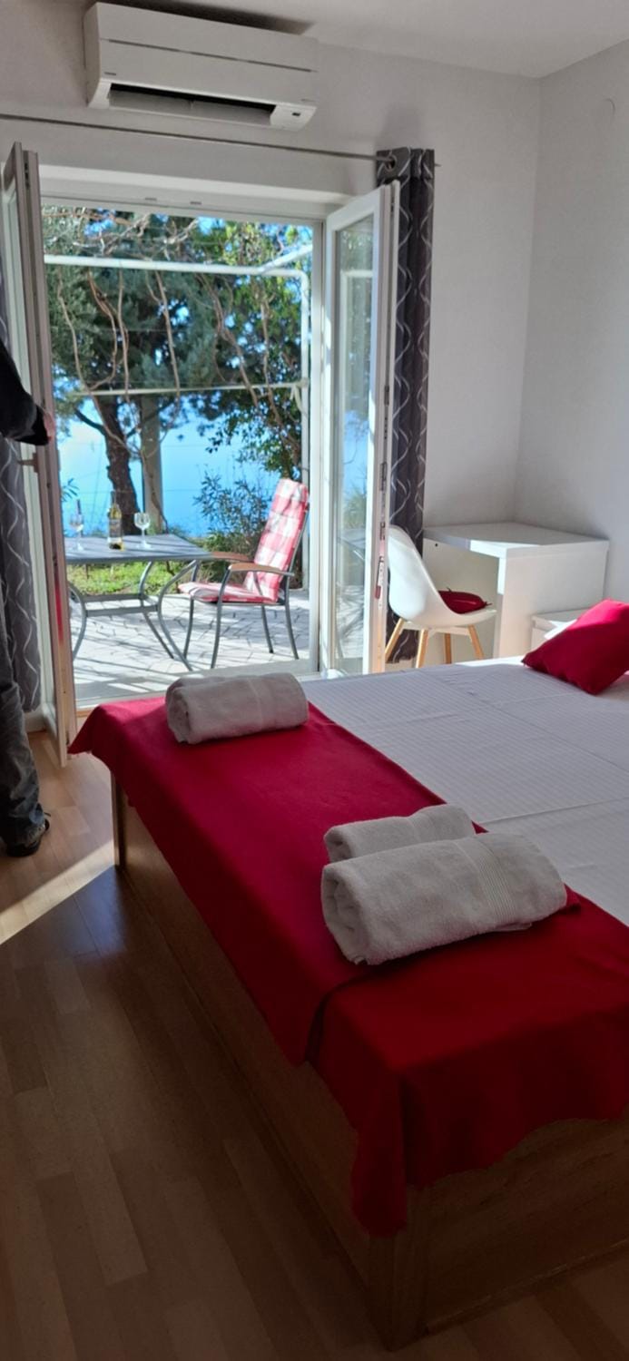 Bed, View (from property/room), Balcony/Terrace, Photo of the whole room, Decorative detail, Bedroom, Text overlay, Sea view, Inner courtyard view, air conditioner