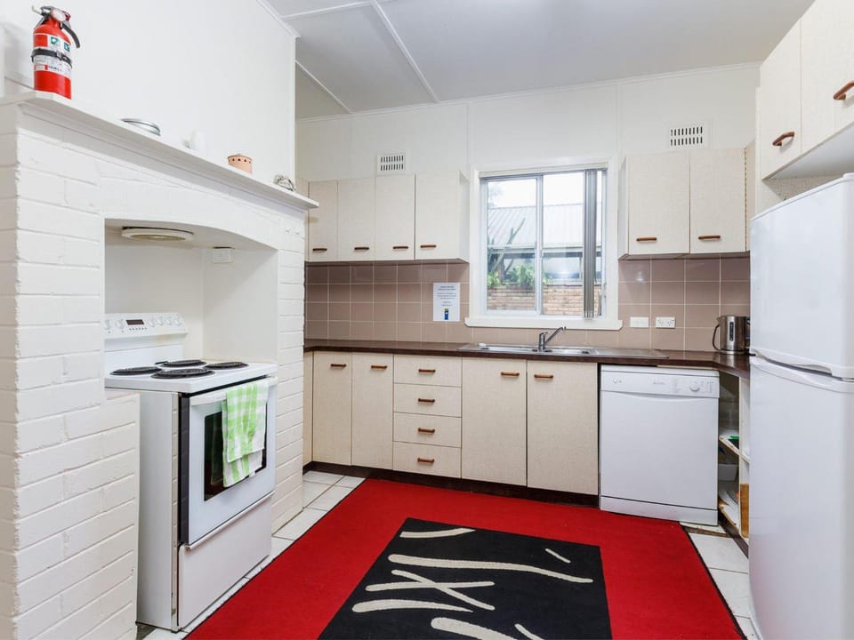 Kitchen or kitchenette, dishwasher, oven, stove