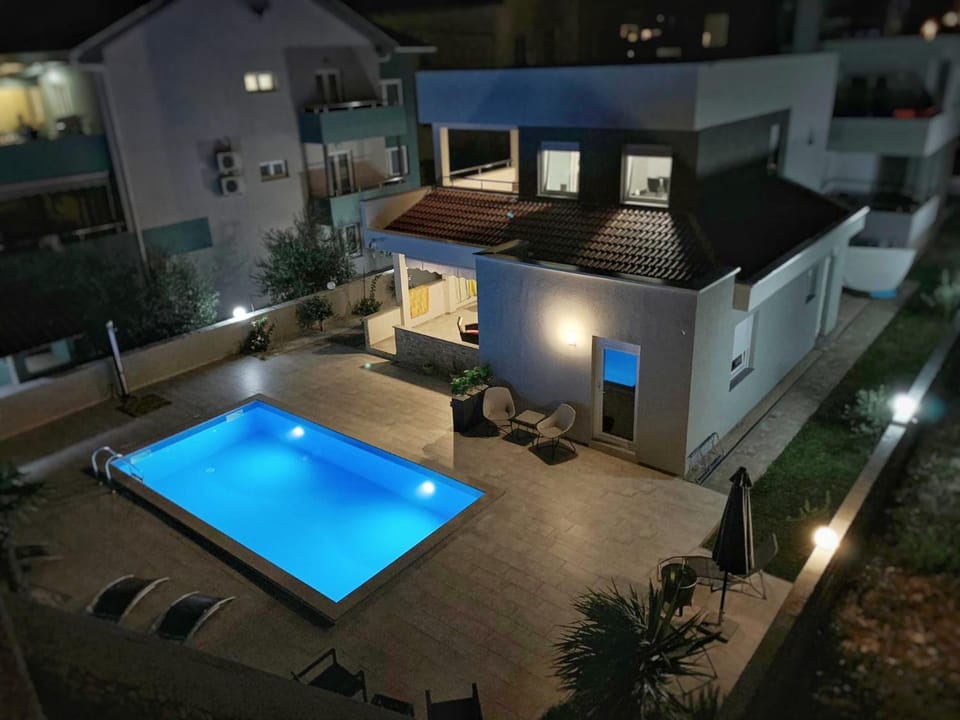 Property building, Patio, Night, Pool view, Swimming pool, sunbed