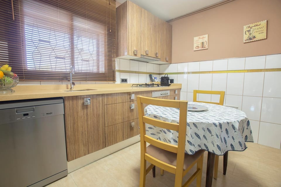 Kitchen or kitchenette, dishwasher, oven, stove