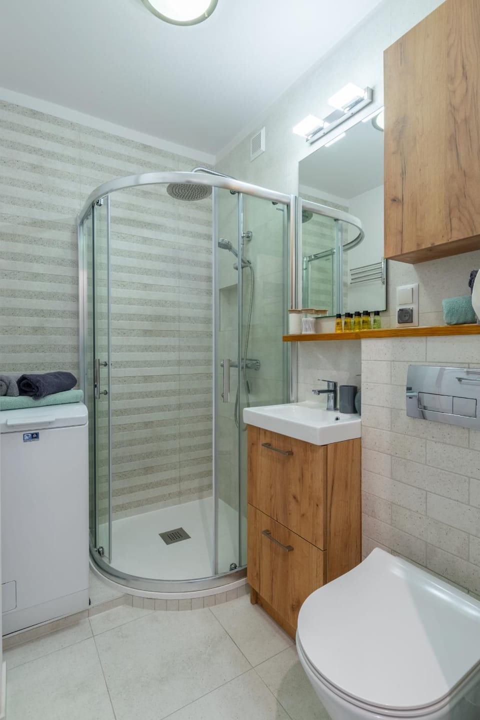 Shower, Toilet, Bathroom, hair dryier, towels, washing machine