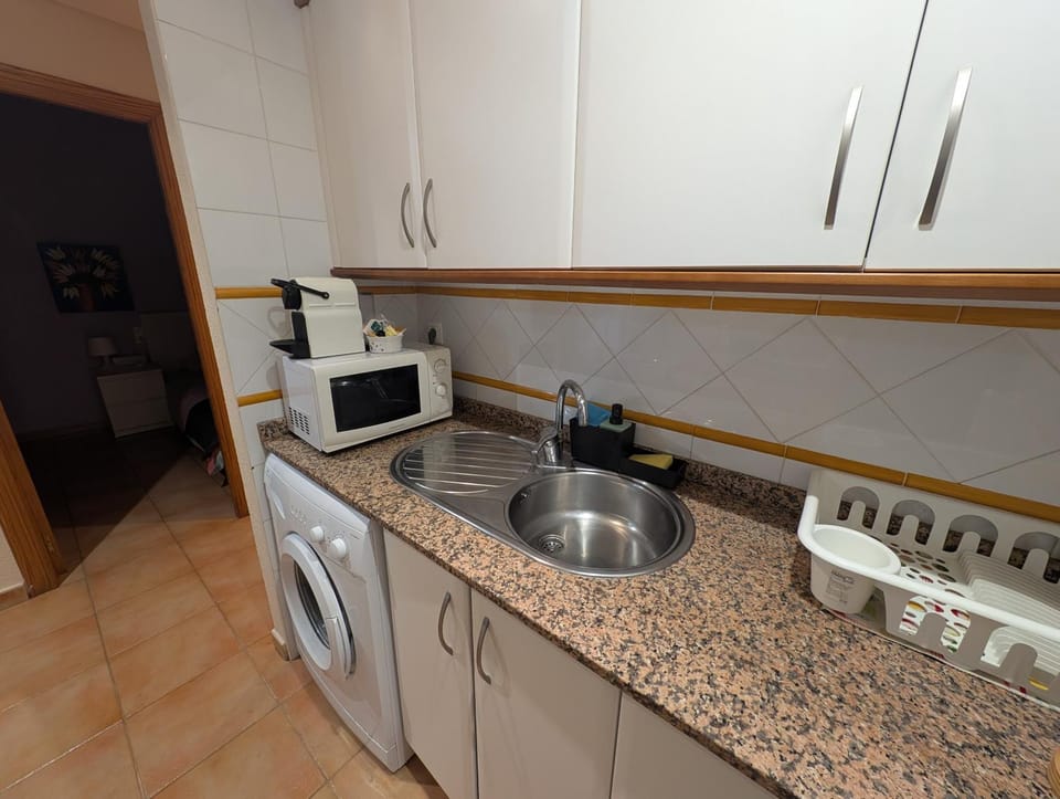 Kitchen or kitchenette, washing machine
