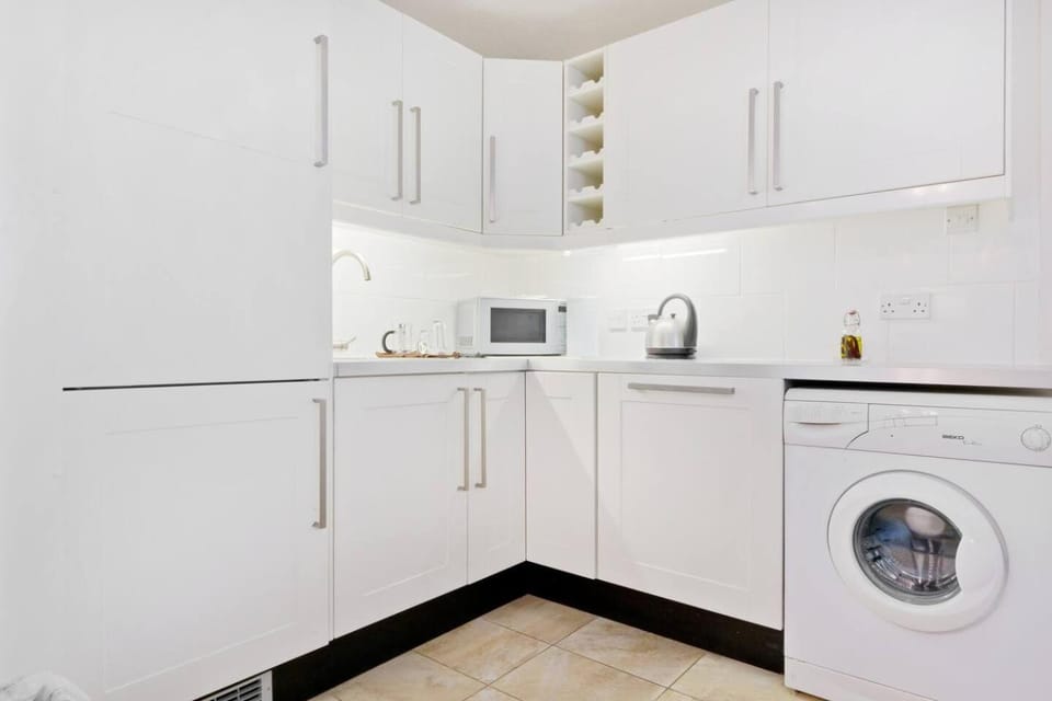 Kitchen or kitchenette, dishwasher, stove, toaster, washing machine