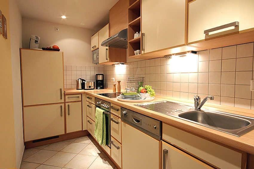 Kitchen or kitchenette, dishwasher, oven, stove