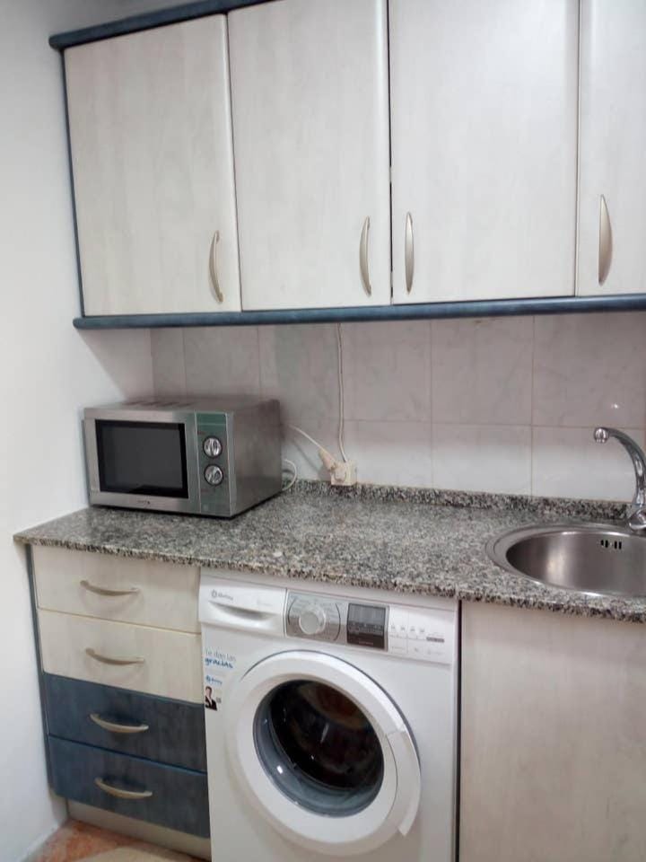 Kitchen or kitchenette, stove, washing machine