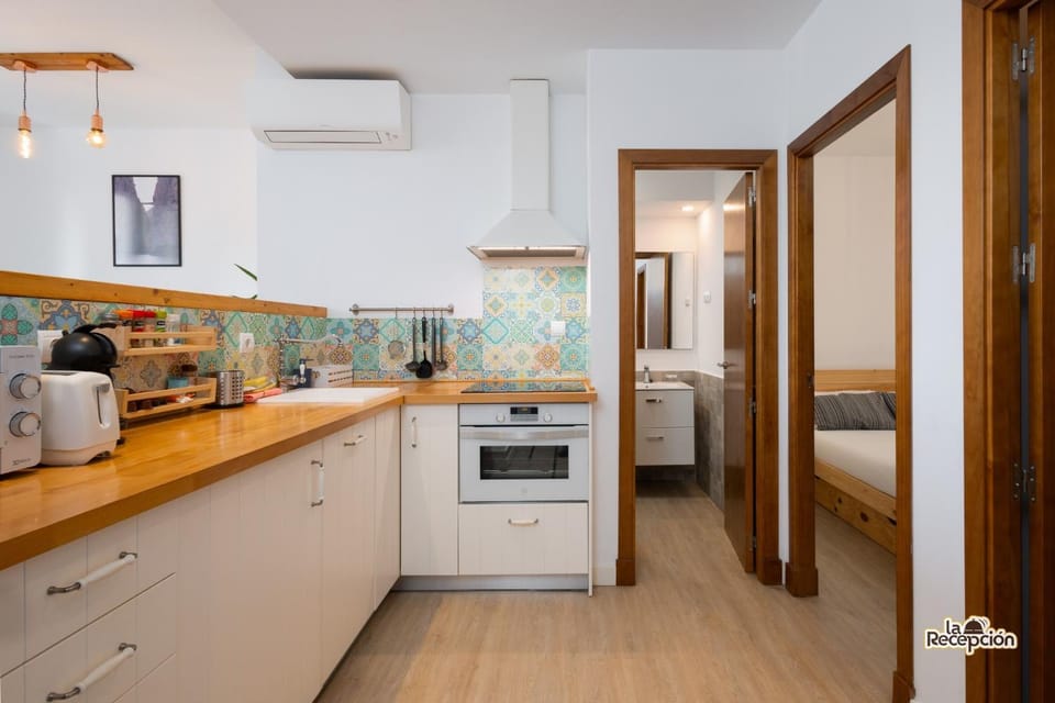 Kitchen or kitchenette, dishwasher, oven, stove, toaster, washing machine