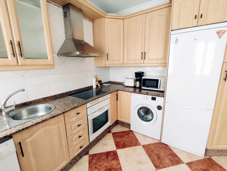 Kitchen or kitchenette, dishwasher, oven, stove, washing machine