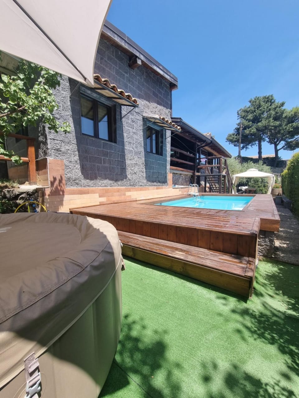 Property building, Patio, Natural landscape, Pool view, Swimming pool, sunbed