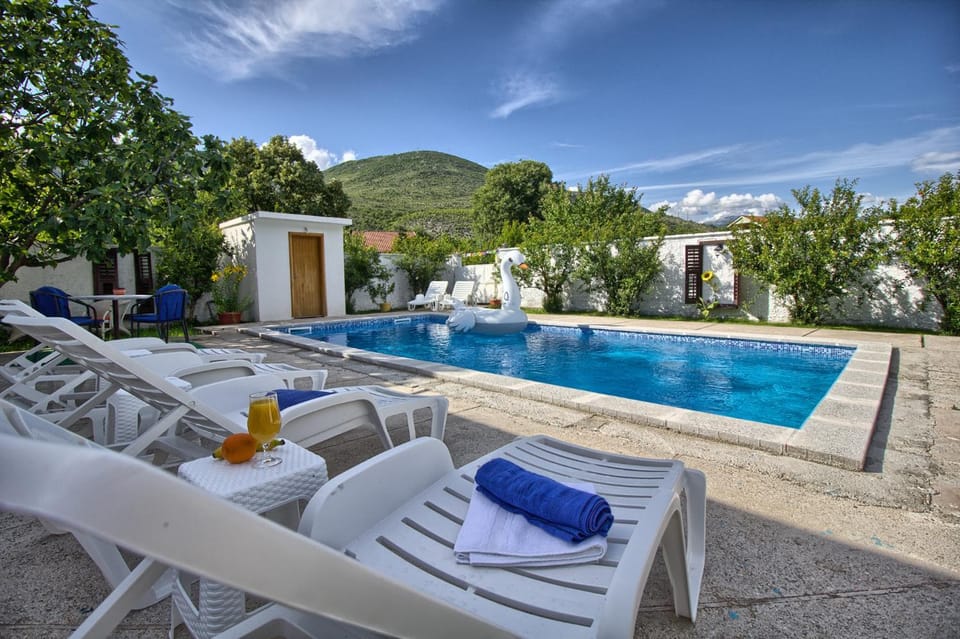 Patio, Spring, Day, Natural landscape, Pool view, Swimming pool, sunbed, towels