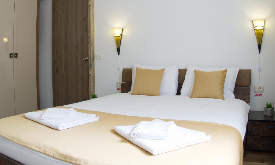 Bed, towels, wardrobe