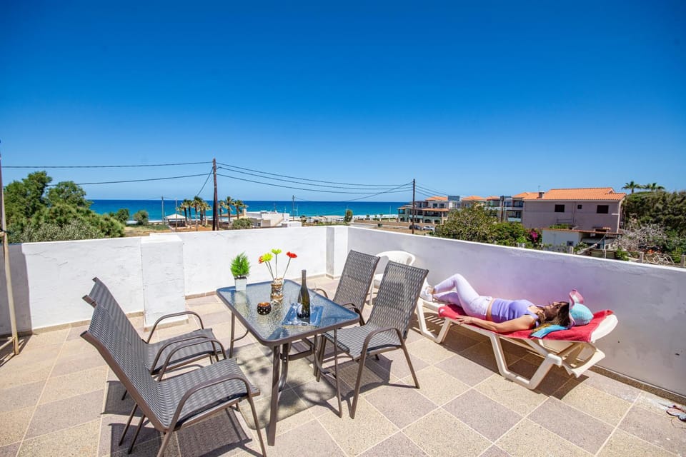 Property building, Patio, Day, Natural landscape, View (from property/room), Balcony/Terrace, Dining area, Beach, Sea view, sunbed