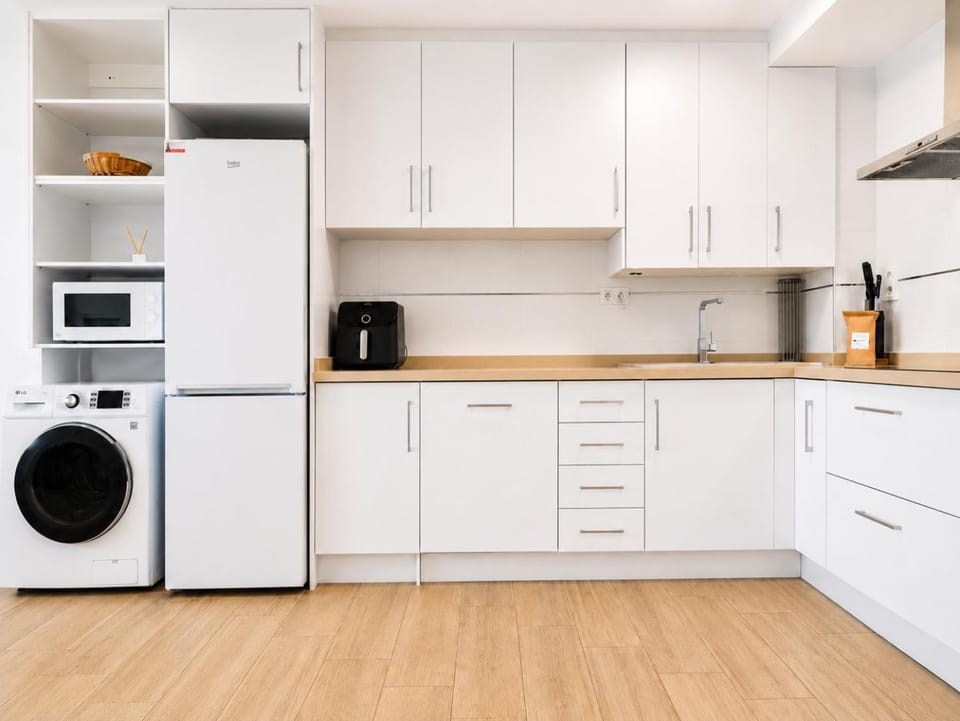 Kitchen or kitchenette, dishwasher, flat iron, microwave, stove, washing machine, kitchen