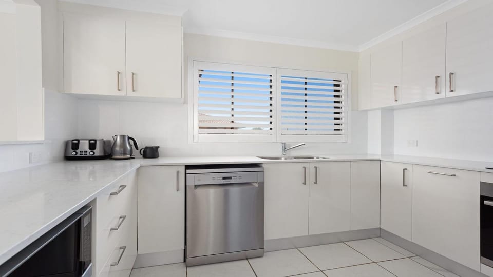 Kitchen or kitchenette, dishwasher, oven, stove