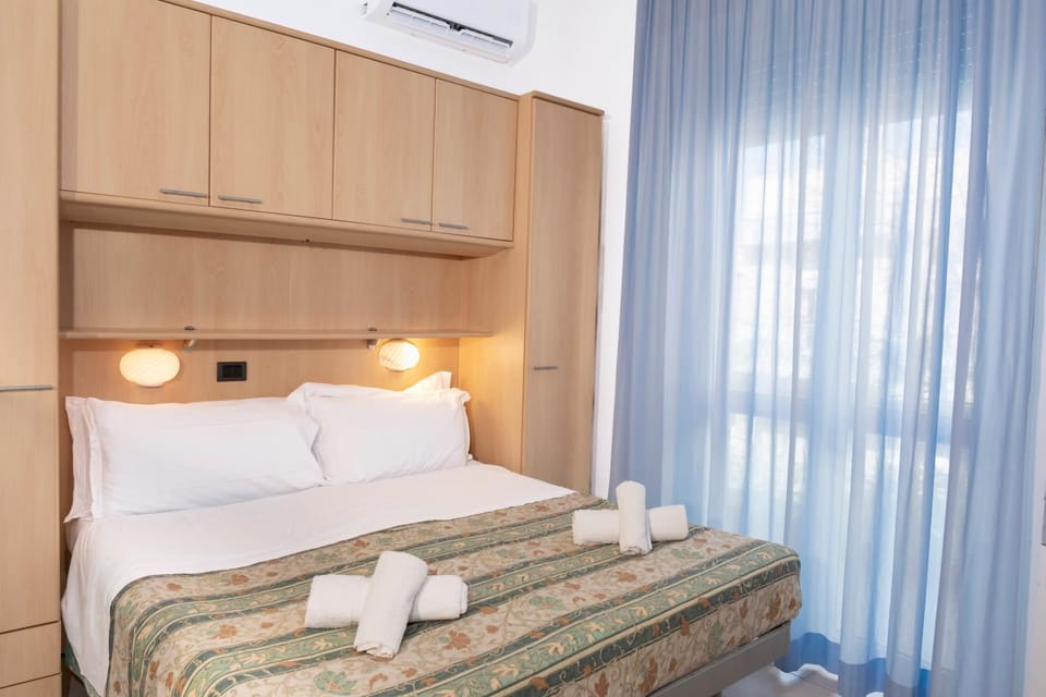 Bed, towels, wardrobe, air conditioner