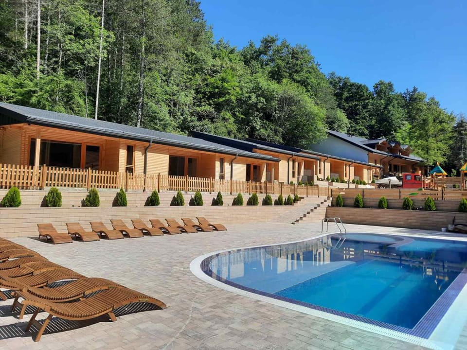 Property building, Patio, Day, Natural landscape, Pool view, Swimming pool, sunbed