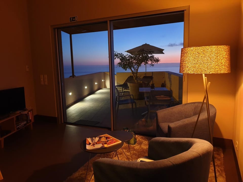 View (from property/room), Balcony/Terrace, Living room, Seating area, Sea view, Sunset