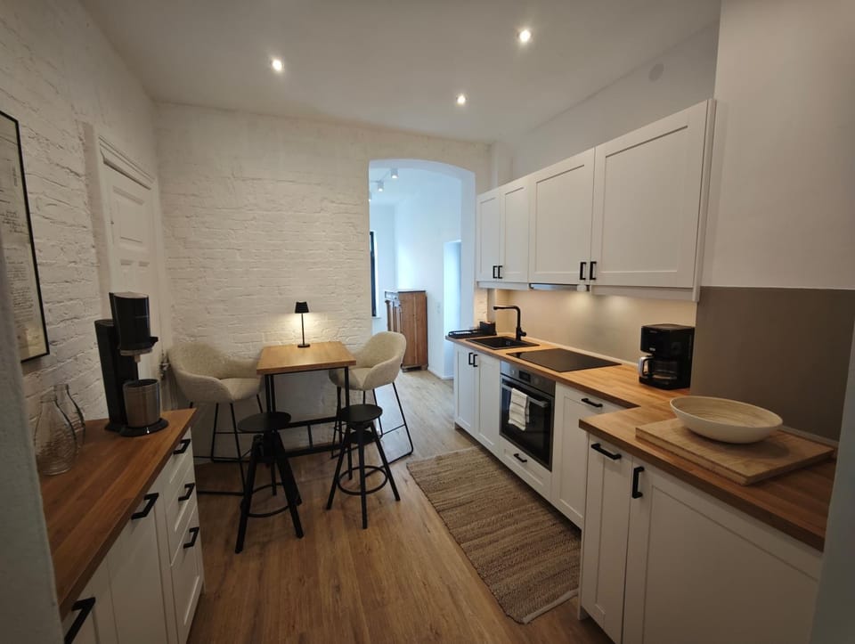 Kitchen or kitchenette, dishwasher, oven, stove