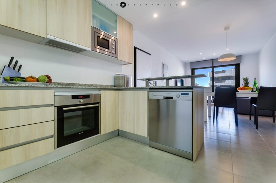 Kitchen or kitchenette, dishwasher, oven, stove