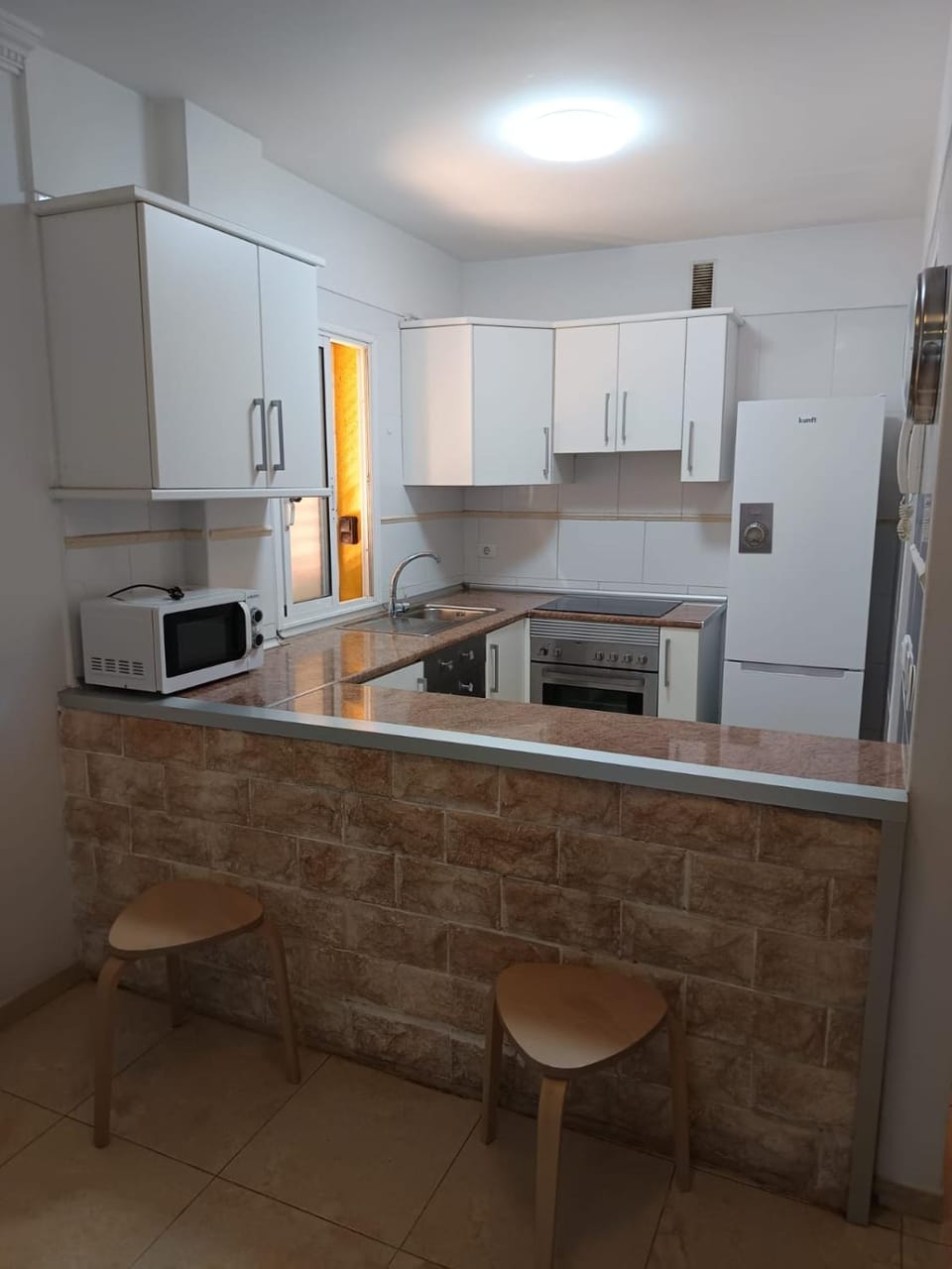 Kitchen or kitchenette, microwave, stove, toaster