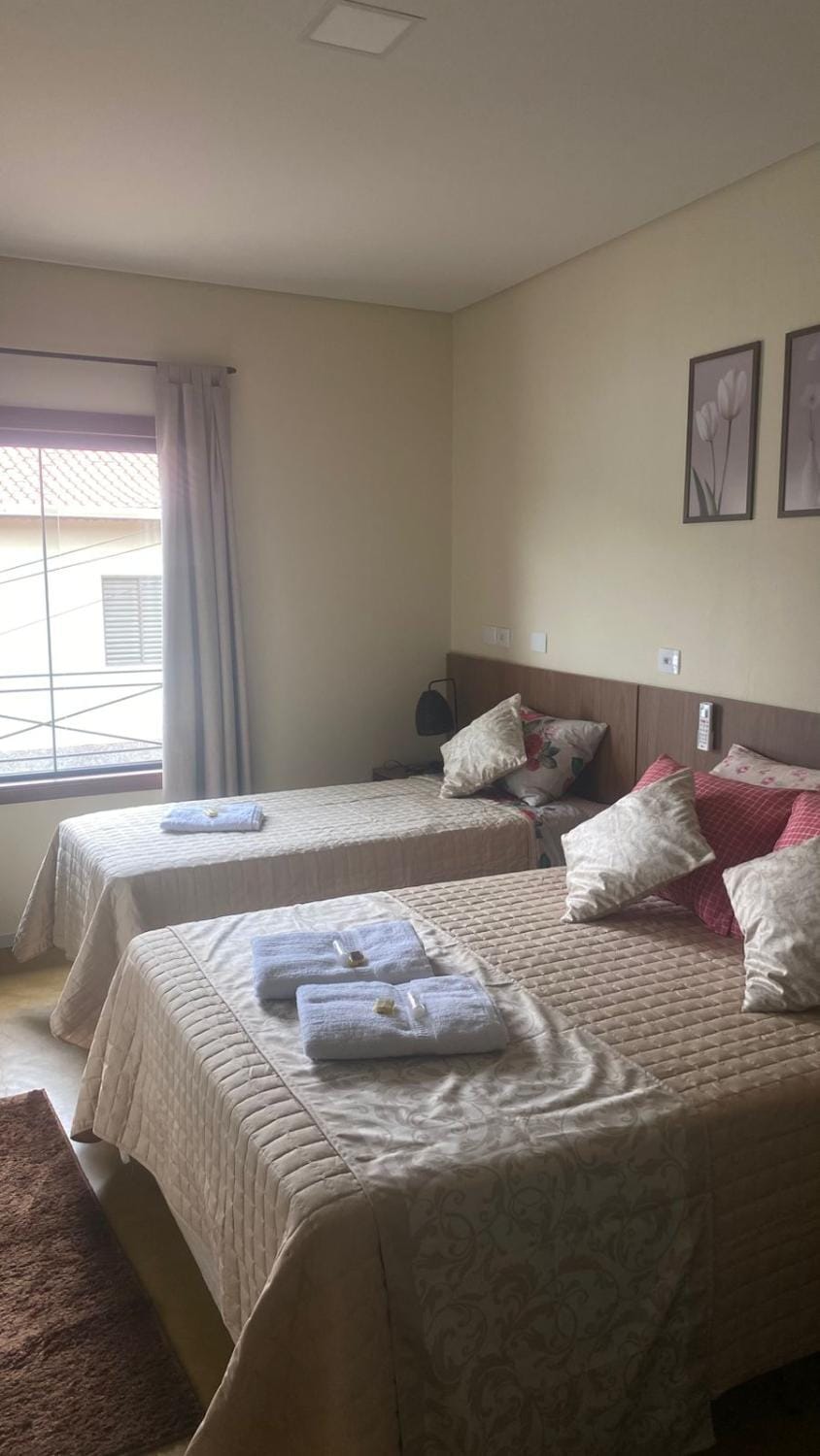 Bed, Bathroom, hair dryier, towels, wardrobe, air conditioner