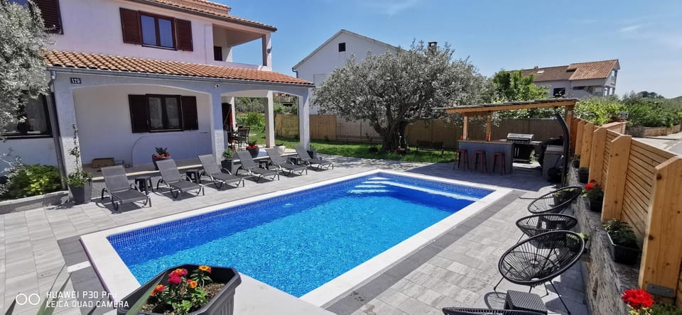 Property building, Patio, Pool view, Swimming pool, sunbed