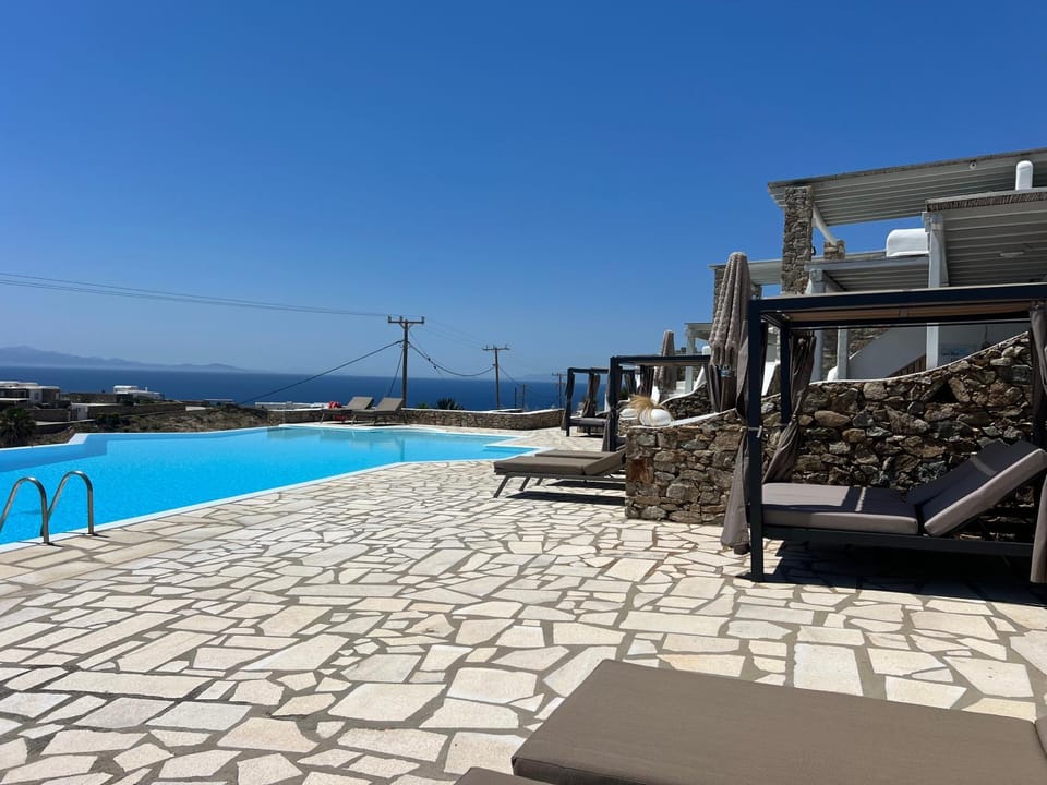 Property building, Patio, Day, Natural landscape, View (from property/room), Pool view, Sea view, Swimming pool, sunbed