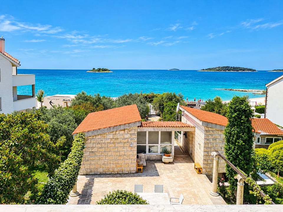 Property building, Patio, Facade/entrance, Day, Natural landscape, Beach, Sea view, Parking