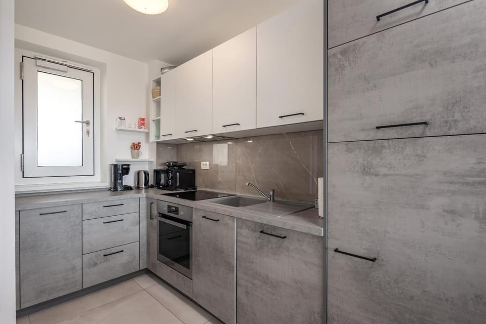 Kitchen or kitchenette, dishwasher, oven, stove, toaster