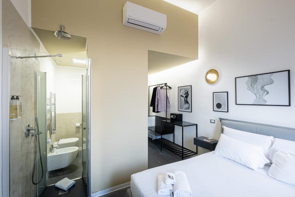 Shower, Toilet, Bed, Bathroom, Photo of the whole room, Bedroom, towels, air conditioner