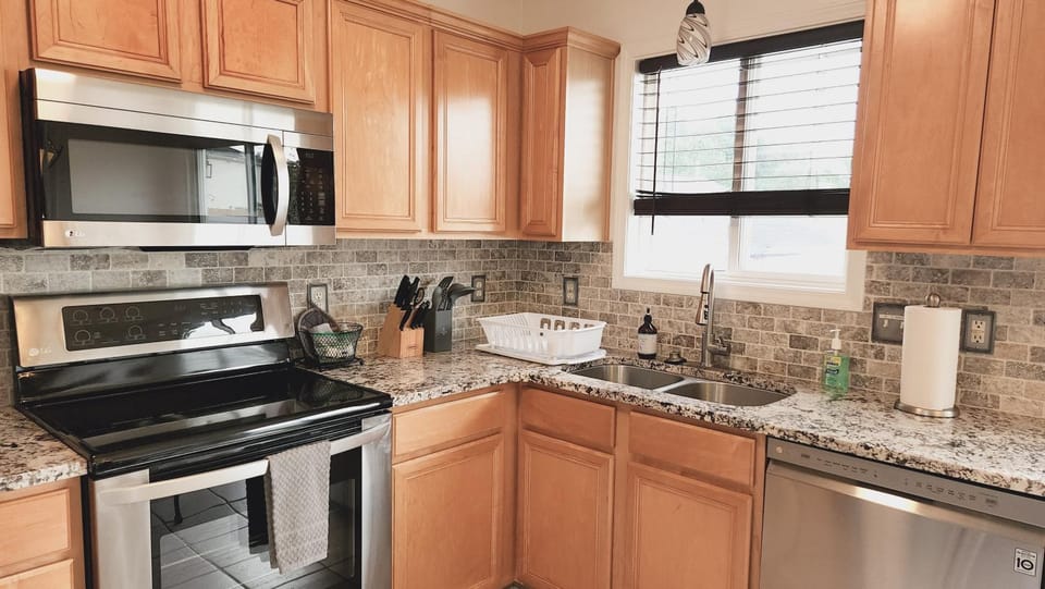 Kitchen or kitchenette, dishwasher, oven, stove
